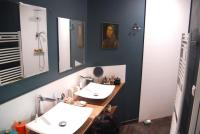 a bathroom with two sinks and two mirrors at Un jardin en ville in Nantes