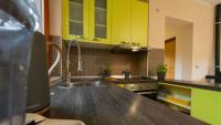 a kitchen with yellow cabinets and a sink at Holiday house Kajfes in Brod na Kupi