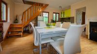 a dining room and kitchen with a table and chairs at Holiday house Kajfes in Brod na Kupi