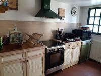 a kitchen with a stove and a sink at les orchidees sauvages in Touffreville-la-Corbeline