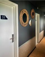 a hallway with a door and plates on the wall at Hôtel Restaurant BO &amp; MIA in La Baule