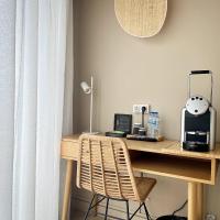 a wooden desk with a coffee maker and a toaster at Hôtel Restaurant BO &amp; MIA in La Baule