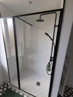 a shower with a glass door in a bathroom at Clos Léonie - appartement 68m2 lumineux avec sauna in Givry