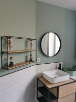 a bathroom with a sink and a mirror at Clos Léonie - appartement 68m2 lumineux avec sauna in Givry