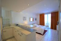 a kitchen with a sink and a bed in a room at Palais Miramar - Suite White Jardin - 20m Plage in Cannes