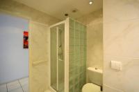 a bathroom with a toilet and a glass shower at Palais Miramar - Suite White Jardin - 20m Plage in Cannes