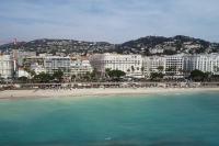 a view of a beach with buildings and the ocean at Palais Miramar - Suite White Jardin - 20m Plage in Cannes