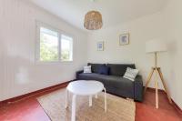 a living room with a couch and a table at Detente au calme et pres de la plage in Saint-Gildas-de-Rhuys