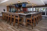 a bar with a row of chairs at a restaurant at DoubleTree by Hilton LAX - El Segundo in El Segundo