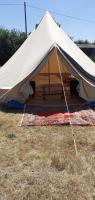 a large tent sitting in a field of grass at La tente saharienne du Perche .Chevaux. 