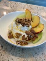 a white plate with nuts and apples and yogurt at Nisaki Mathraki B&B in Corfu Town