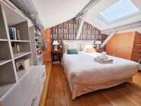 a bedroom with a large bed in a attic at Beau et vaste duplex plateau Angoulême in Angoulême