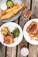 a table with three plates of food and french fries at Stirrups Hotel in Bracknell