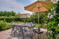 a table and chairs with an umbrella on a deck at Havre de paix pour 10 a l Ile de Re in La Flotte