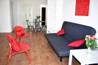 a living room with a black couch and red chairs at F4 MimiPinson 1er étage Rabinon lac riviere VAR in Le Muy