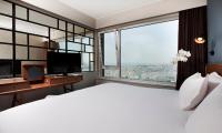 a bedroom with a large bed and a large window at The Marmara Pera in Istanbul