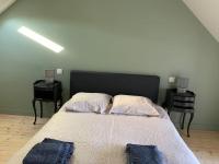 ein Schlafzimmer mit einem großen Bett mit zwei Nachttischen in der Unterkunft Robert&#39;s Family Petite Maison de Ville in Plancoët