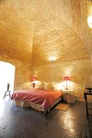 A bed or beds in a room at Posada Real Castillo del Buen Amor