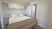 a bedroom with a large white bed with white walls at Cottage JANICE Beach in Pakoštane
