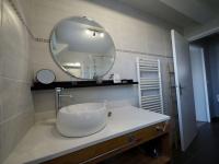 a bathroom with a sink and a large mirror at Cap Marine - Petit cocon à Etel in Étel