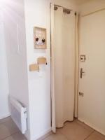 a bathroom with a white refrigerator and a door at L&#39;Ornella Dom Studio en copropriété in Marseille