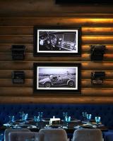 a dining room with two pictures of a car on the wall at Hotel Golden Lion & SPA in Smyha
