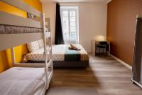 Łóżko lub łóżka w pokoju w obiekcie LD-Location Hôtel