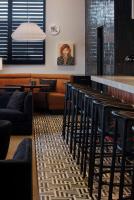 a restaurant with a bar and some chairs and tables at The Haywood, Tapestry Collection by Hilton in El Dorado