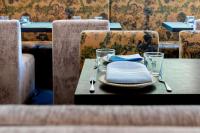 a wooden table with a plate of food on it at The Exchange Sacramento, Curio Collection By Hilton in Sacramento