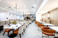 a dining room with white tables and chairs at Doubletree Sulphur Lake Charles in Sulphur