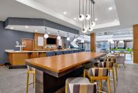 a large dining room with a long table and chairs at DoubleTree by Hilton Davenport in Davenport