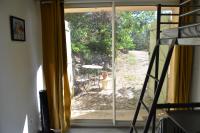 a room with a sliding glass door with a ladder at Maison Amandre en Pleine Nature - Mas Lou Castanea in Collobrières