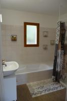 a bathroom with a white tub and a sink at Maison Amandre en Pleine Nature - Mas Lou Castanea in Collobrières
