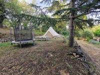 a swing in a yard with a tent at Maison Amandre en Pleine Nature - Mas Lou Castanea in Collobrières