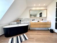 a bathroom with a large tub and two sinks at LUXURY ! Maison spacieuse de standing – Proche des plages in Ploemeur