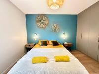 a bedroom with a large bed with yellow pillows at LUXURY ! Maison spacieuse de standing – Proche des plages in Ploemeur