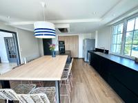 a kitchen with a large wooden table and chairs at LUXURY ! Maison spacieuse de standing – Proche des plages in Ploemeur