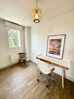 a room with a desk and a chair and a chandelier at LUXURY ! Maison spacieuse de standing – Proche des plages in Ploemeur