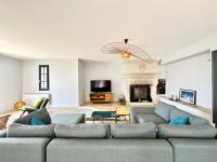 a living room with a couch and a fireplace at LUXURY ! Maison spacieuse de standing – Proche des plages in Ploemeur