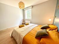 a bedroom with a large orange bed with a chair at LUXURY ! Maison spacieuse de standing – Proche des plages in Ploemeur