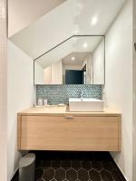 a bathroom with a sink and a mirror at LUXURY ! Maison spacieuse de standing – Proche des plages in Ploemeur