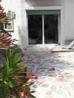a patio with a stone floor and a window at Gîte Acellu in Bonifacio