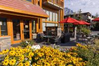 a restaurant with tables and chairs and yellow flowers at Moose Hotel and Suites in Banff