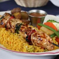 a plate of food with chicken and rice and vegetables at Parc du Mont-Citadelle in Saint-Honoré-de-Témiscouata