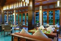 ein Restaurant mit Tischen, Stühlen und Fenstern in der Unterkunft Marriott's Mai Khao Resort - Phuket in Mai Khao Beach