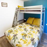 a bedroom with a bunk bed with a ladder at Auberge des Plaines - Appartements avec terrasse in Arles