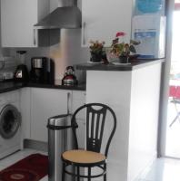a kitchen with a counter and a chair in a kitchen at Maison de 2 chambres avec vue sur la mer jardin amenage et wifi a Vieux Habitants a 2 km de la plage in Vieux-Habitants