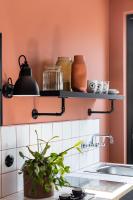 a kitchen with a sink and a shelf on the wall at Deskopolitan House in Paris