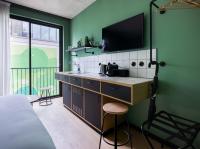 a kitchen with a sink and a tv on a green wall at Deskopolitan House in Paris