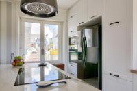 a kitchen with a stainless steel refrigerator and a window at Paisible escale pres de la plage in Plobannalec-Lesconil